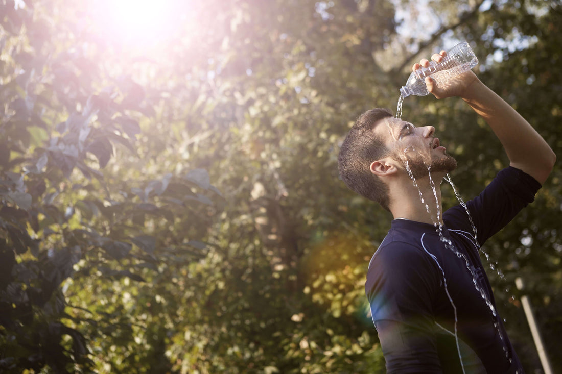 Man pouring water on himself