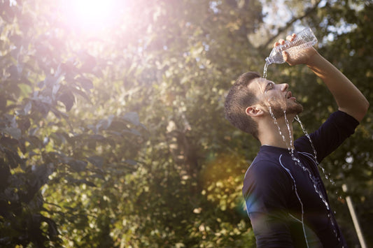 Man pouring water on himself
